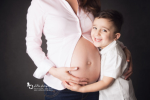 Maternity photographer North Vancouver- JaNa Photography - baby boy smiling on his mom belly