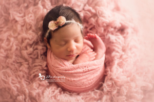 newborn baby girl in a pink fur | jana photography North Vancouver
