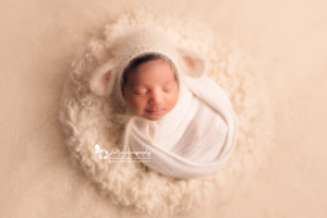 newborn baby girl with cute sheep hat - white fur