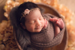 baby girl in a brown basket - smile | jana photography
