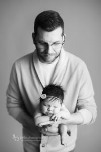 dad is holding newborn baby girl - black and white photography - jana