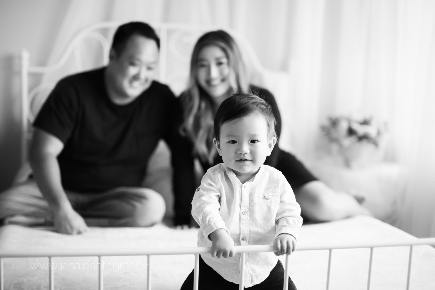 cake smash - baby photography -natural light bed with mom and dad - black and white