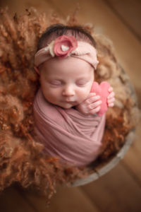 affordable vancouver newborn photography - baby girl holding heart