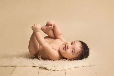 baby 9-month-old boy smiling to the camera