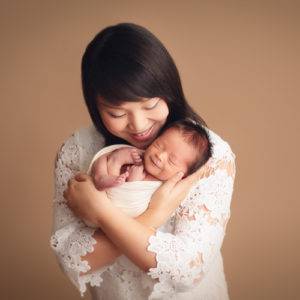 newborn photography Vancouver - mom and baby boy is smiling