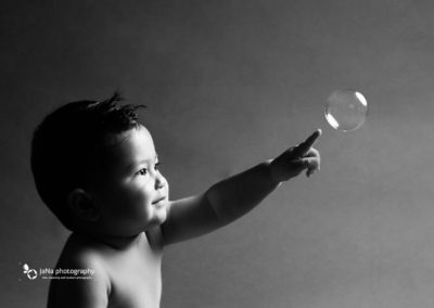 black and white baby boy pointing bubble | jana photography