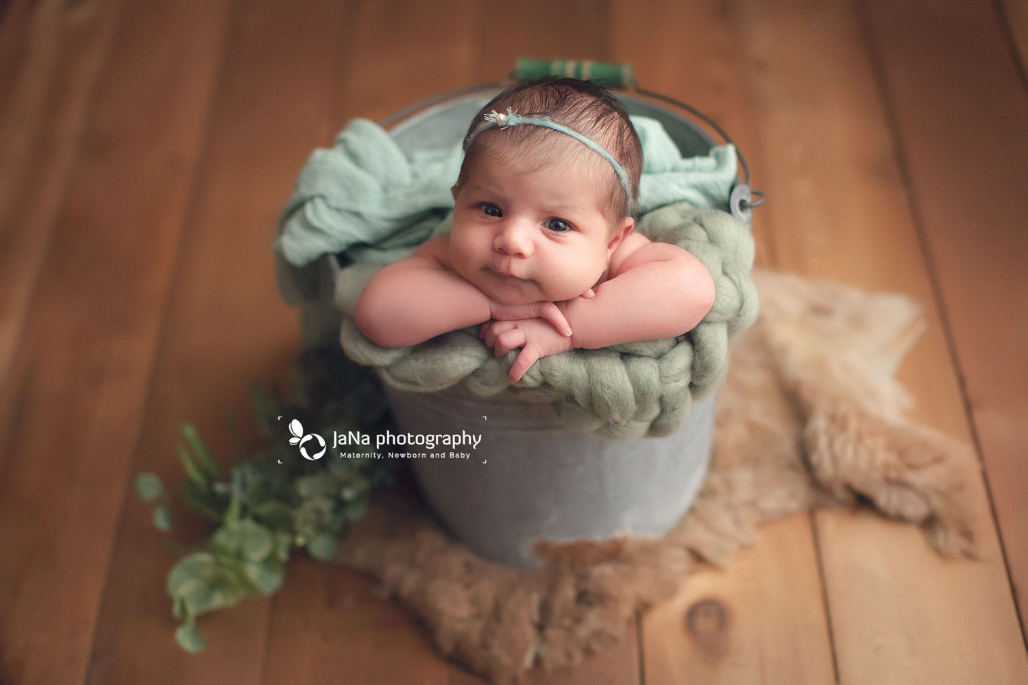 baby girl posing in a bucket with open eyes | jana photography