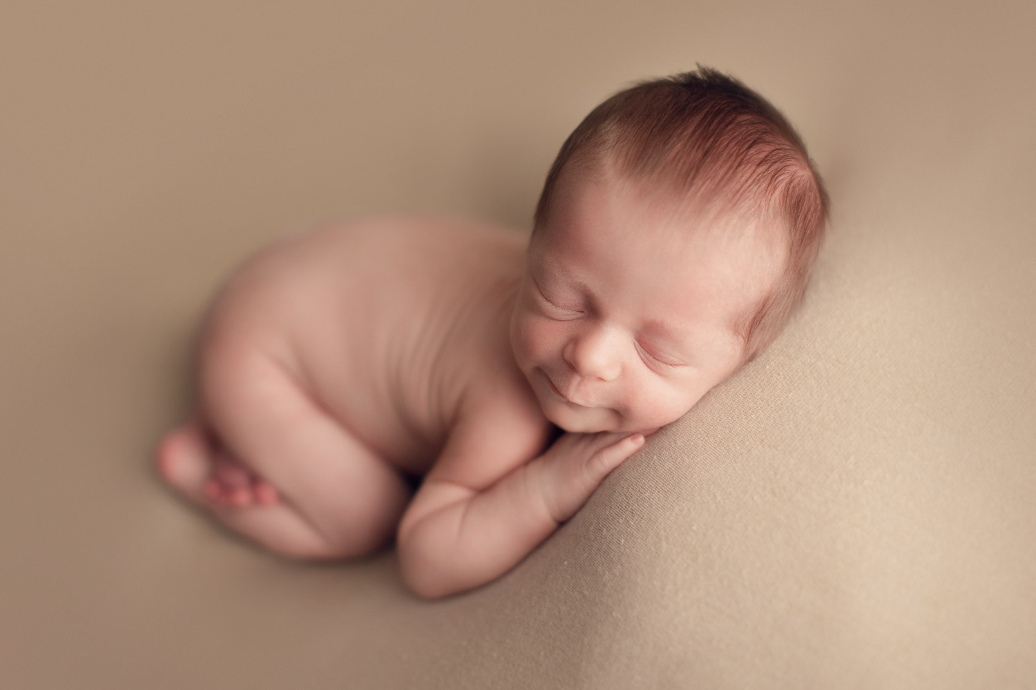 vancouver newborn photography | baby boy smile in a cream background