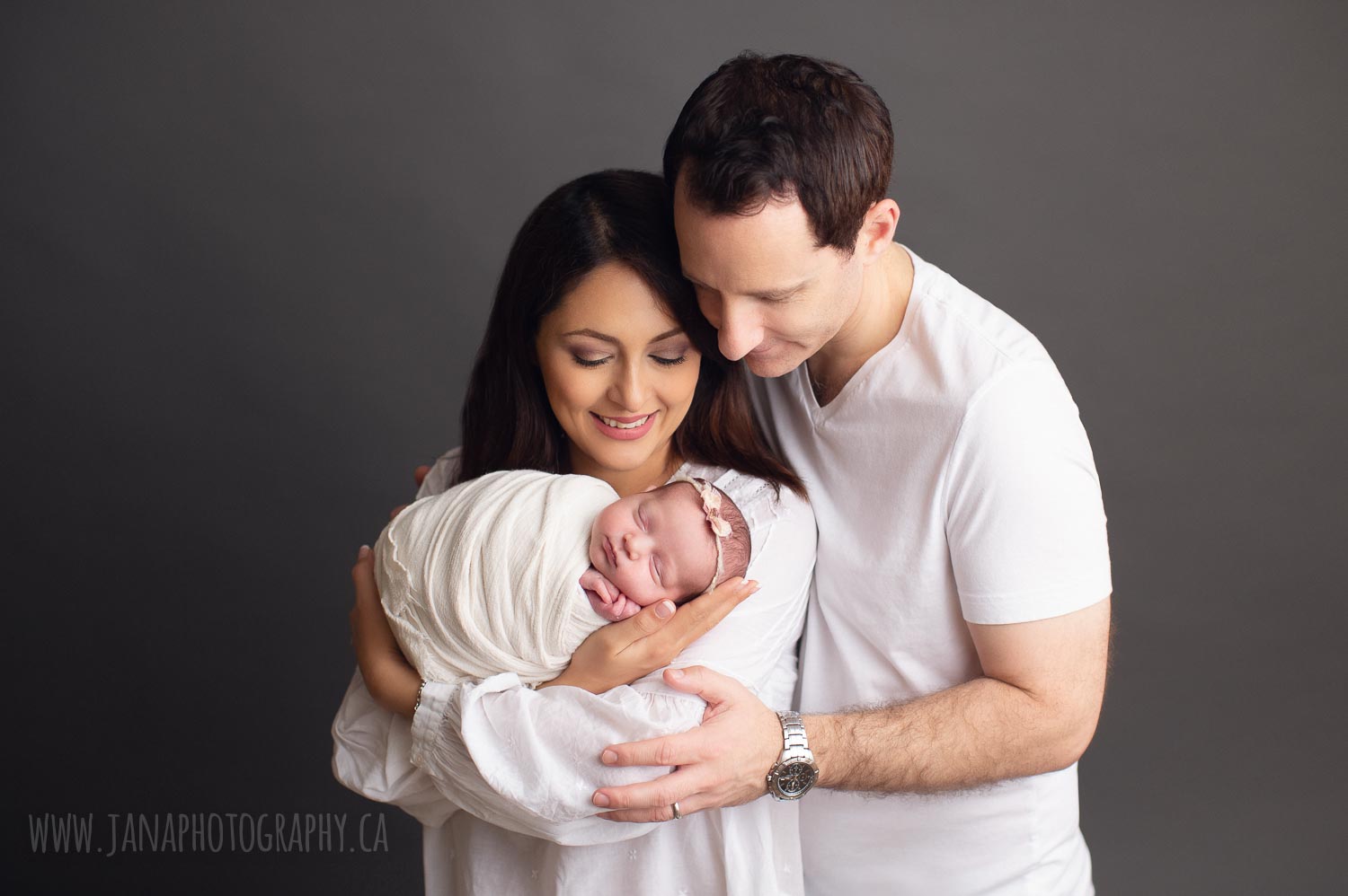 newborn photography vancouver - mom is holding baby girl - grey background