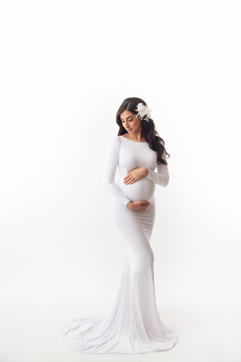 maternity photo with a white dress gown in a white  background