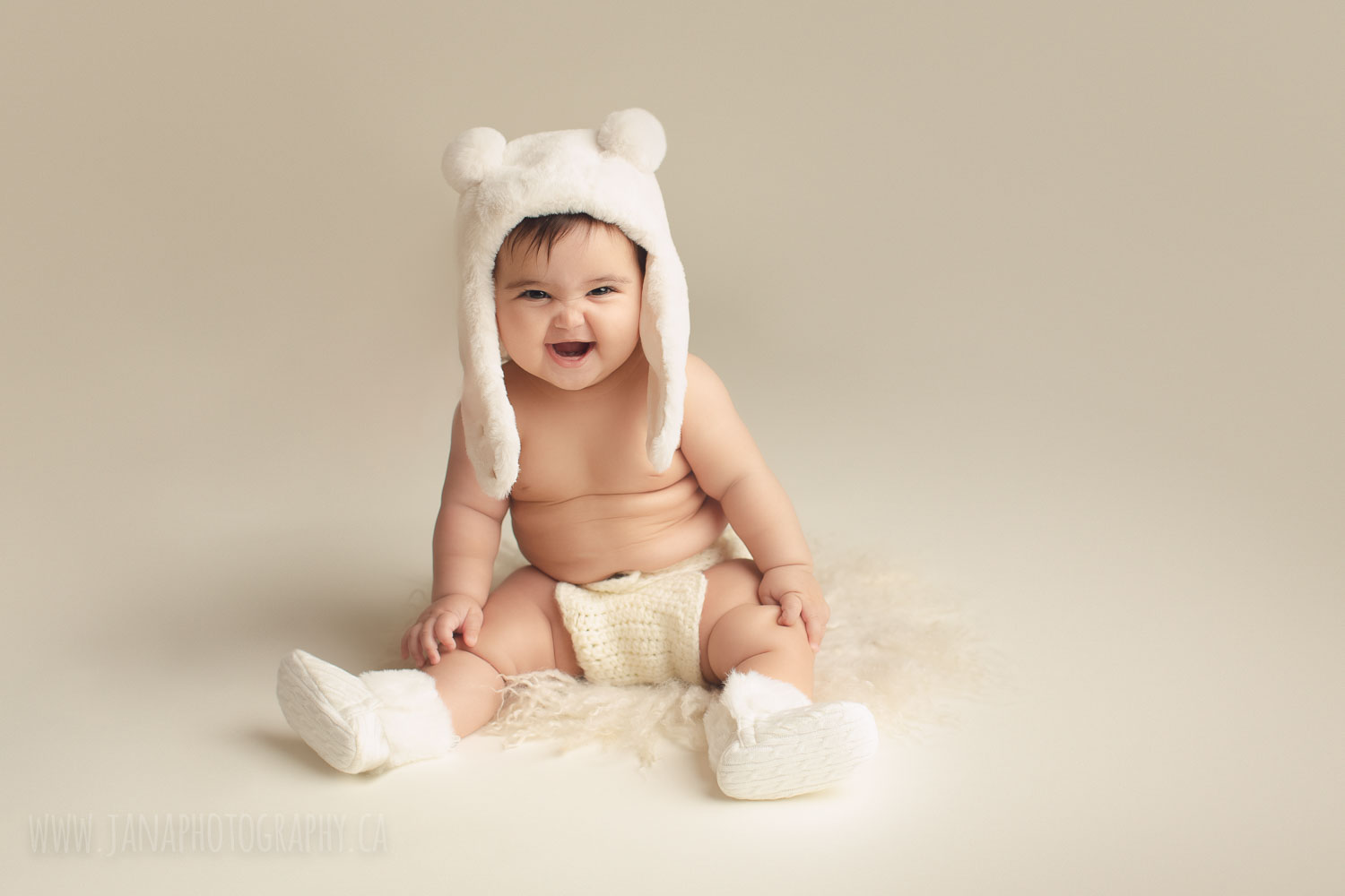 newborn photography - baby girl sleeping in a white bed