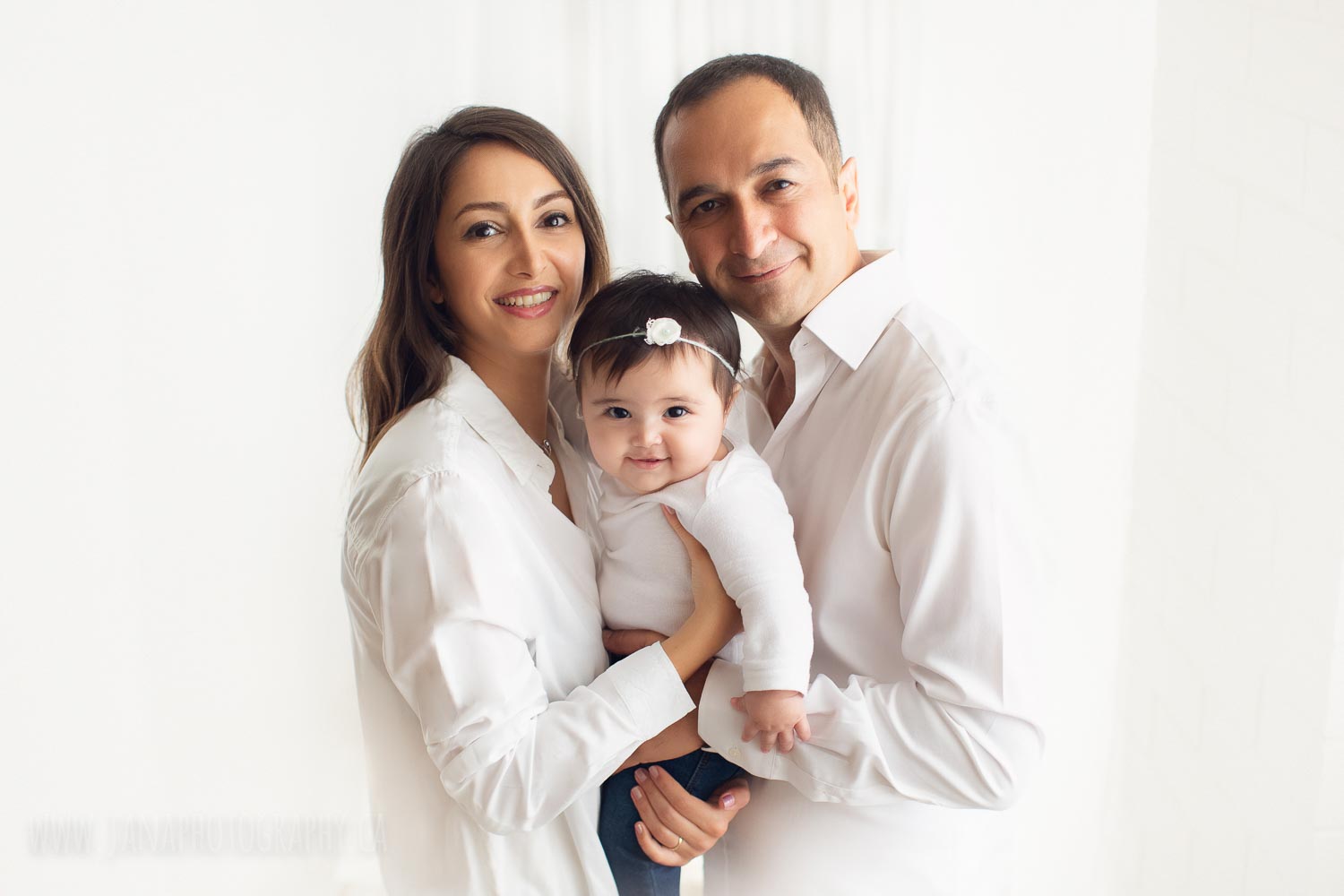 Happy family in baby photography session white background