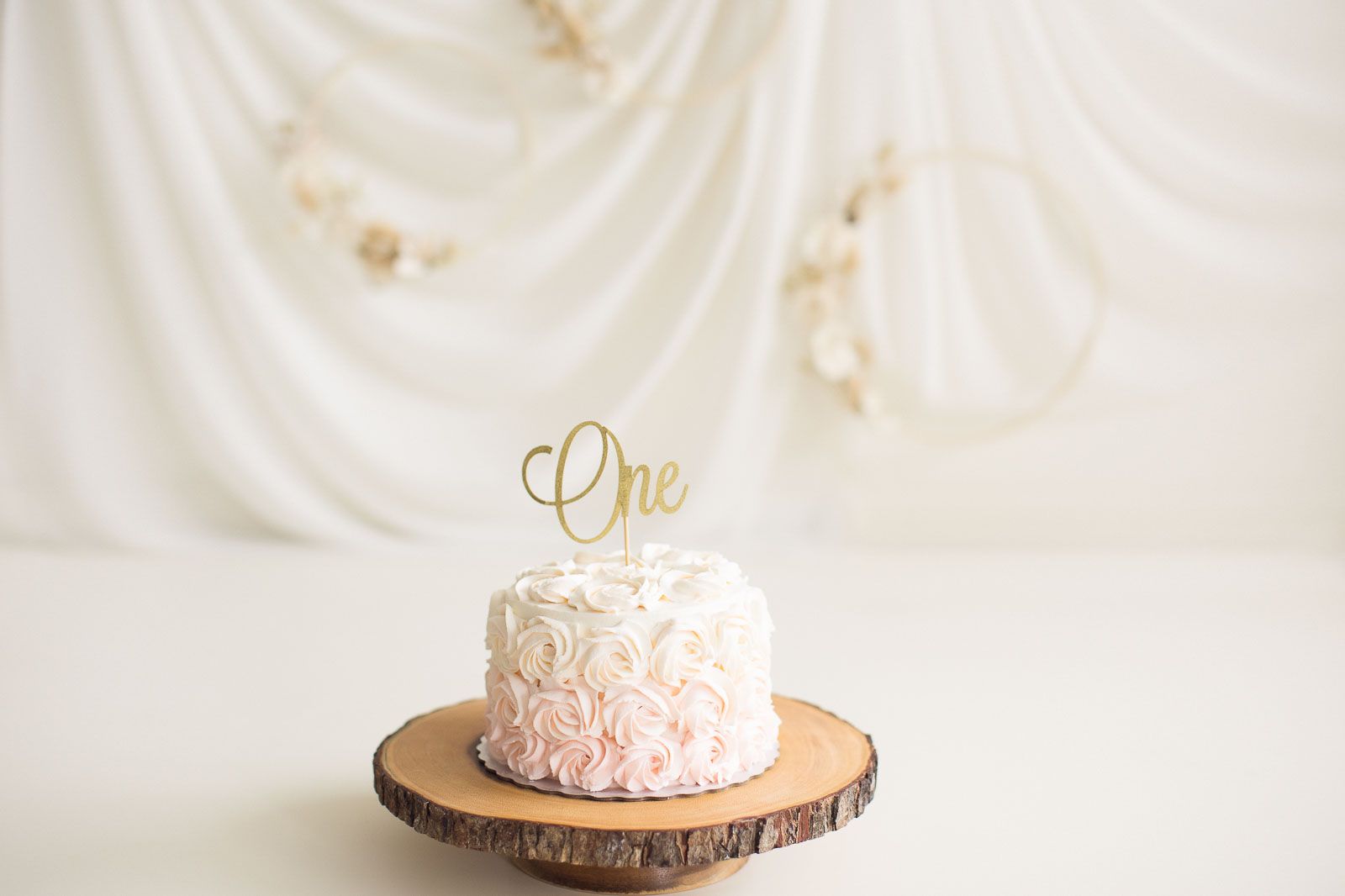 simple and timeless pink and white cake setup for girls