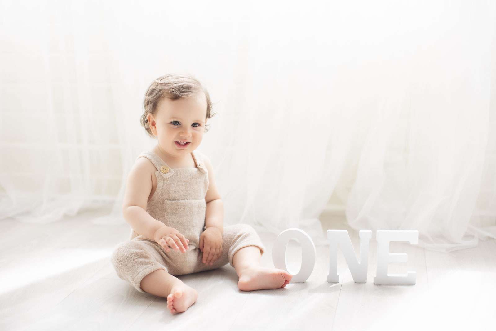 one year old boy in a timeless white background