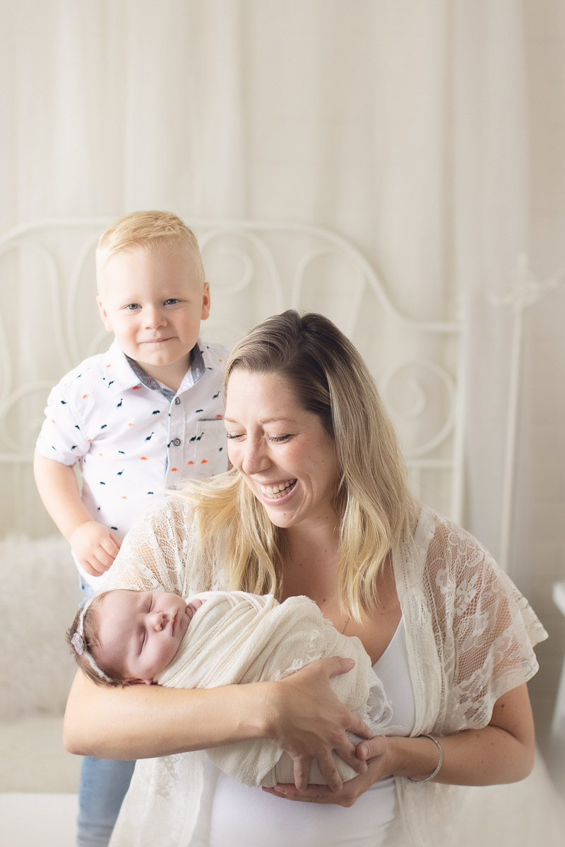 newborn baby girl - smile - yellow background