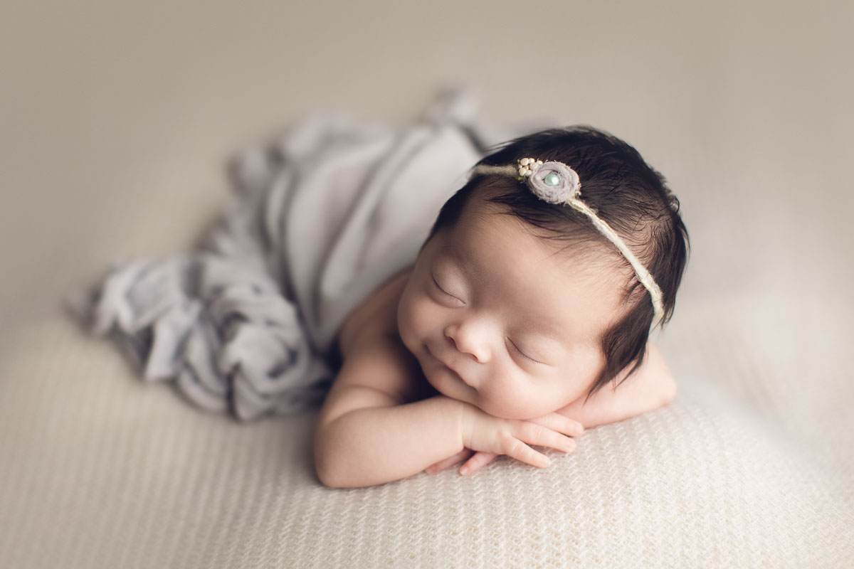 newborn photography girl in light grey background
