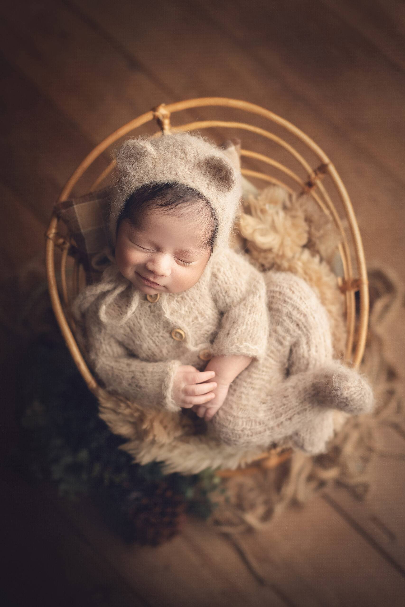 newborn baby boy with a bear outfit 