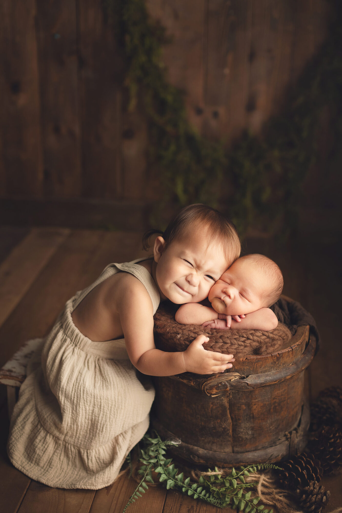 baby boy with his sister in a brown bucket - vancouver