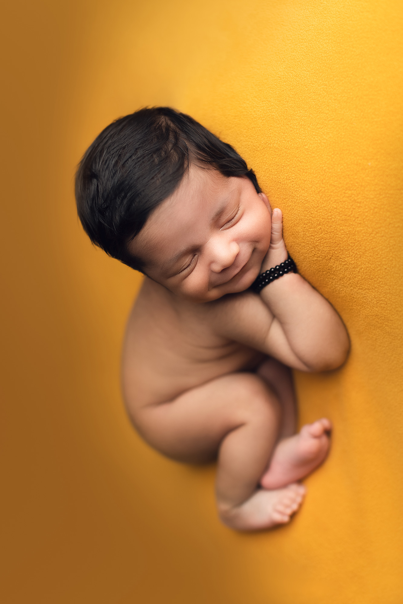 baby boy -sleeping on a yellow setup background