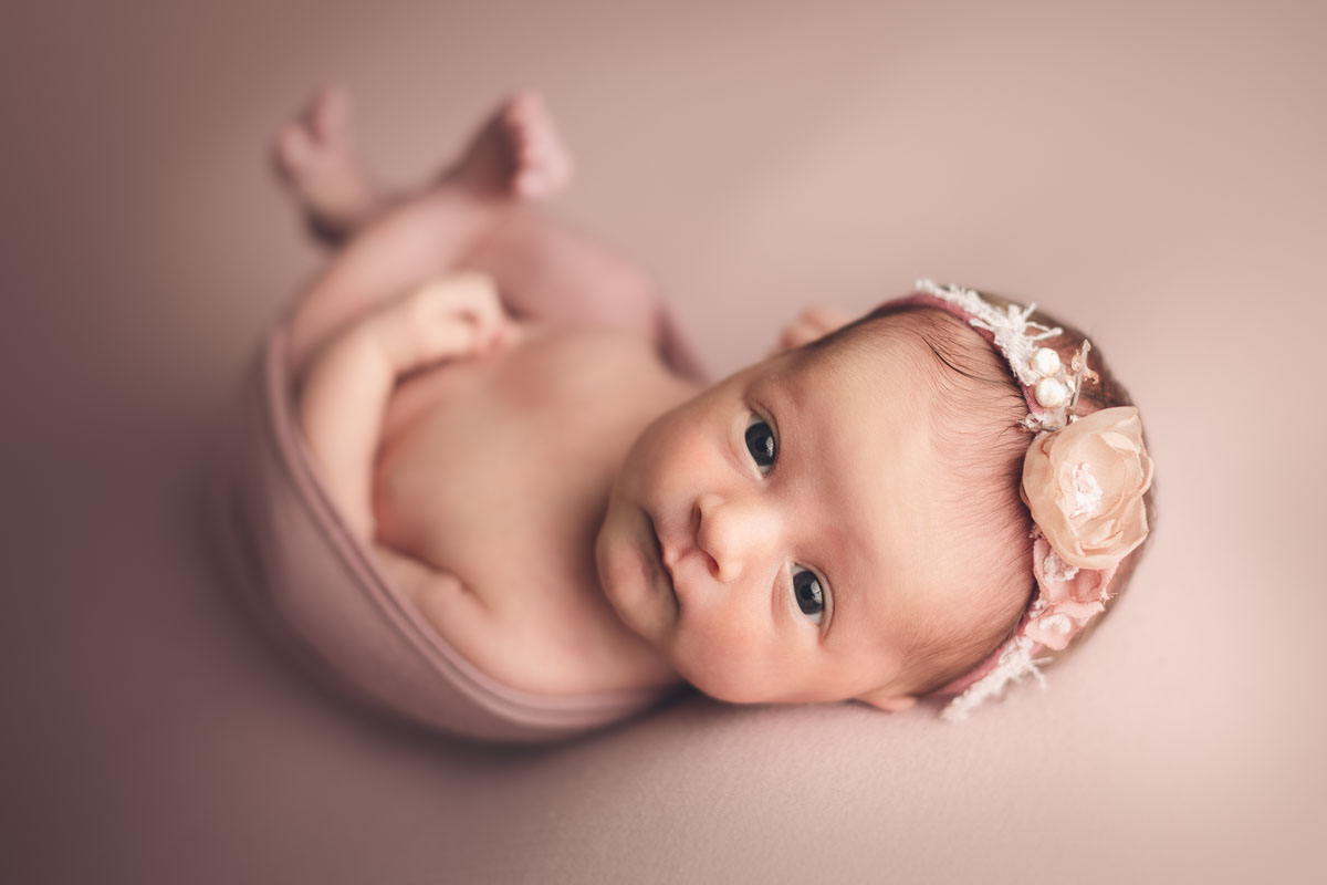 newborn baby girl with open eyes in a pink background - Vancouver - Burnaby and surrey - newborn photography