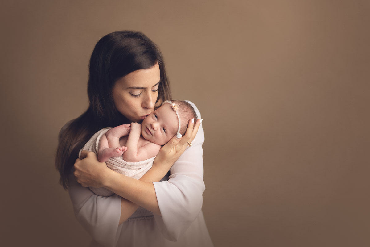 Vancouver - Burnaby and surrey - newborn photography - mom holding baby girl on a studio light brown background