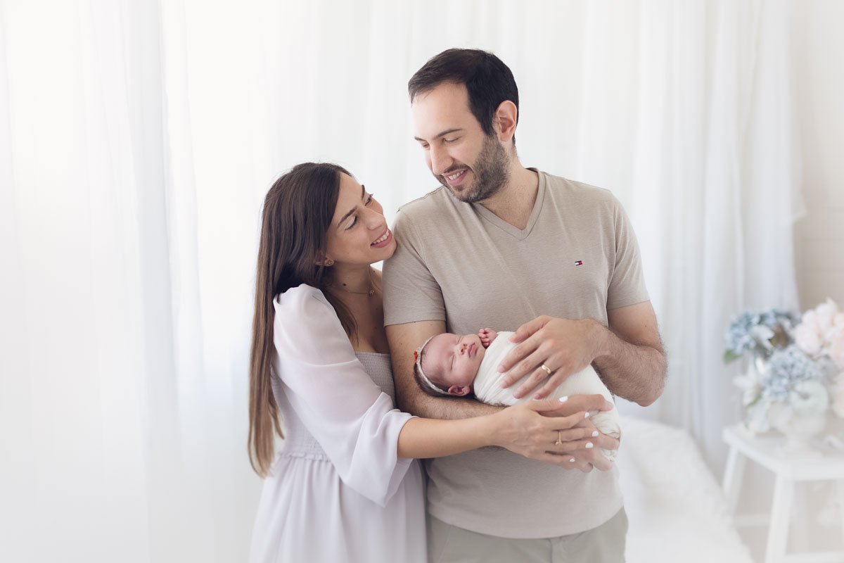 Vancouver - Burnaby and surrey - newborn photography - mom and dad holding baby girl on a natural light studio
