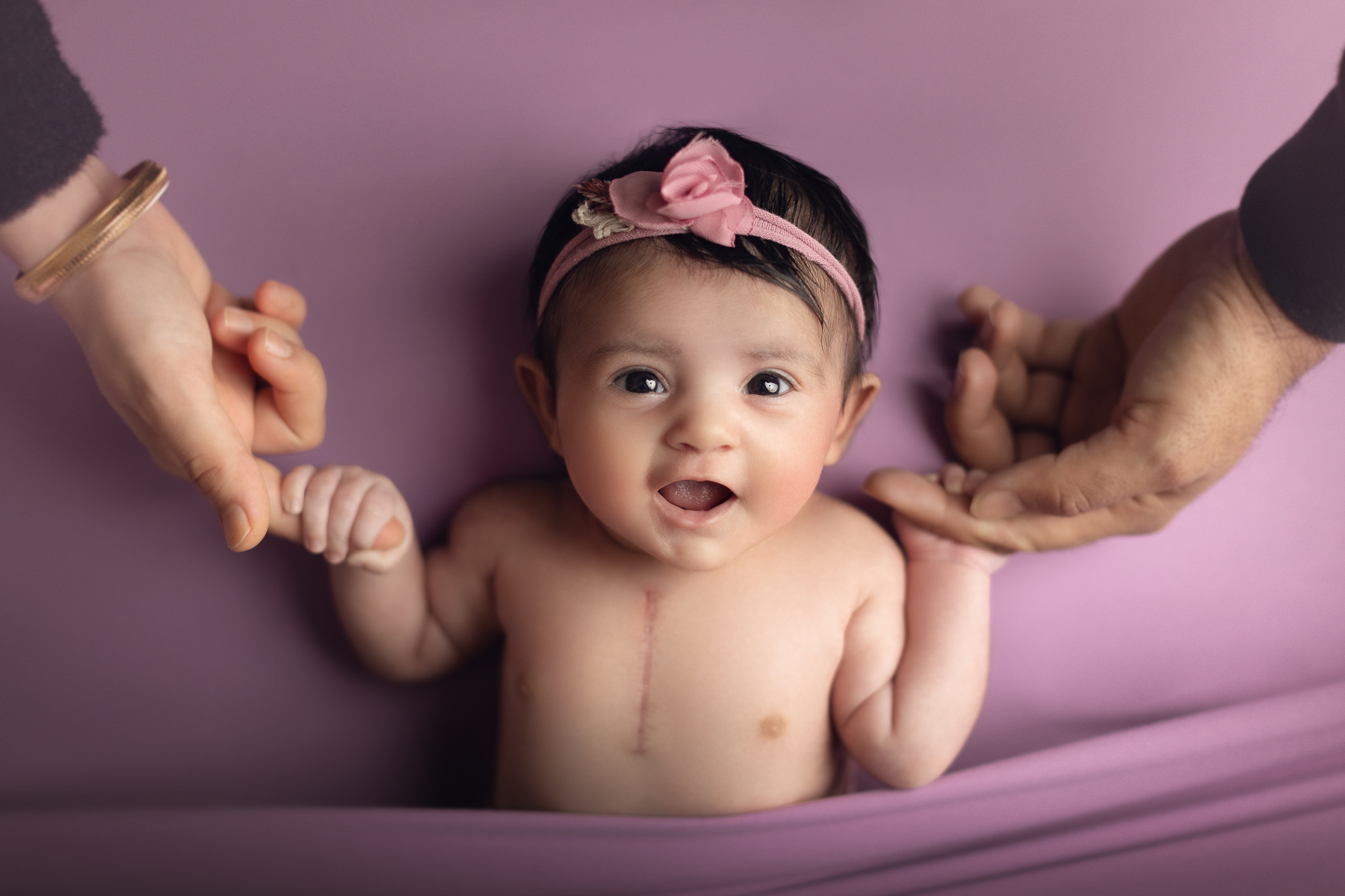 newborn baby girl holding mom and dad's hand. vancouver, burnaby and surrey newborn photography