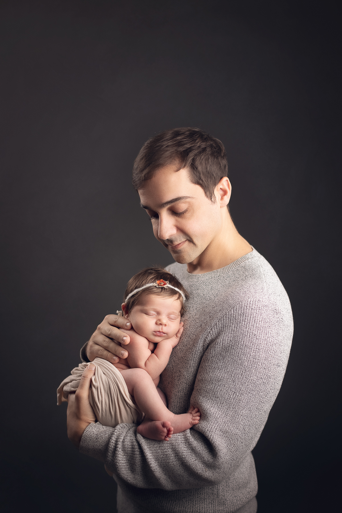 dad holding newborn baby girl - best maternity and newborn photography