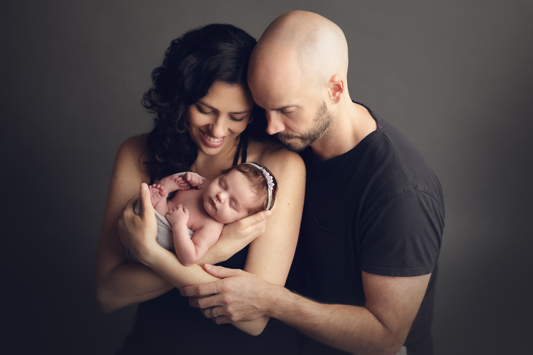 dad holding newborn baby girl - best maternity and newborn photography