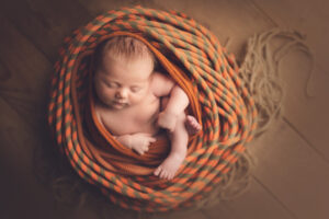 newborn photography with orange rock climbing rope - ice climbing