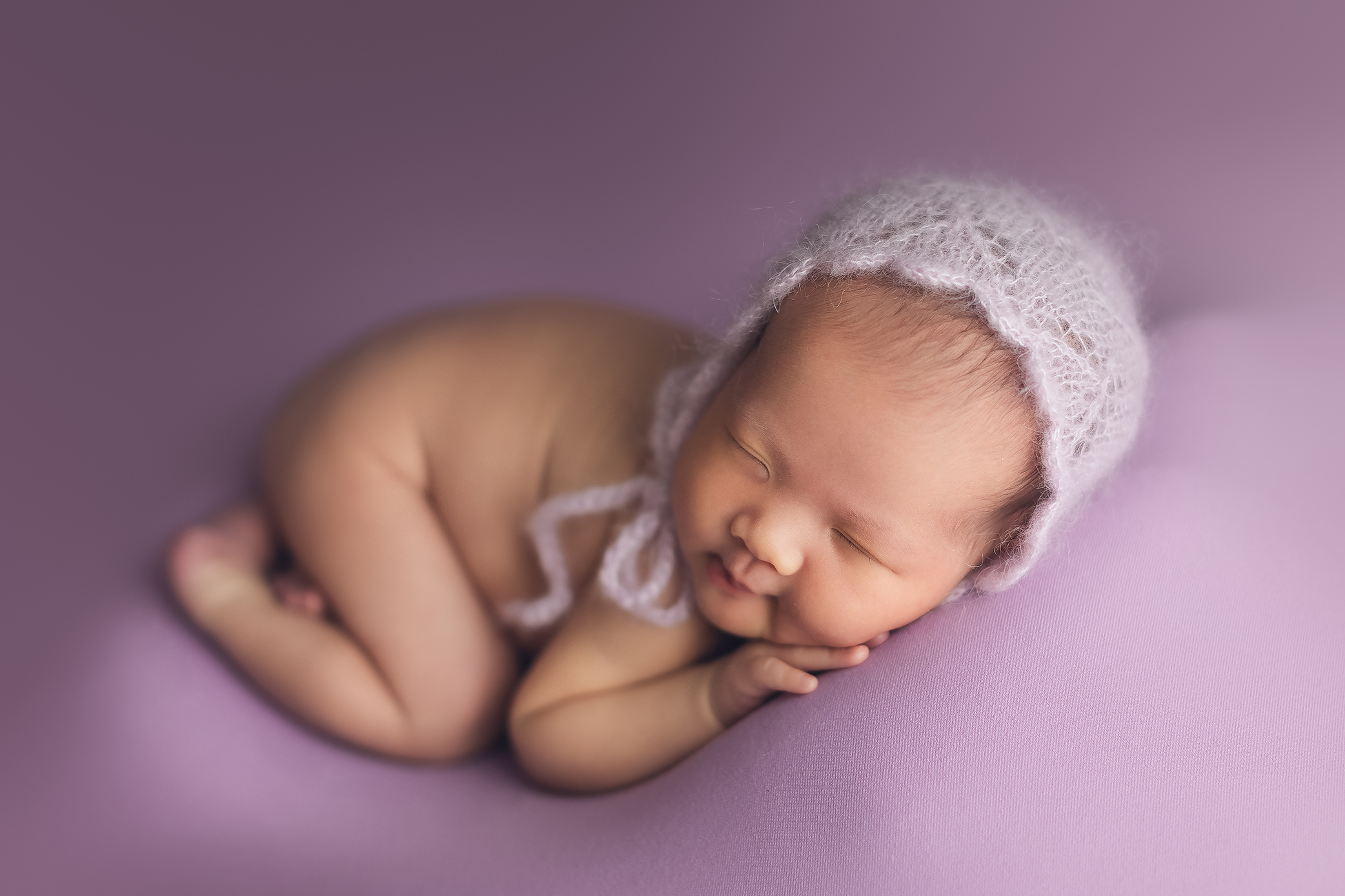 newborn photography purple background