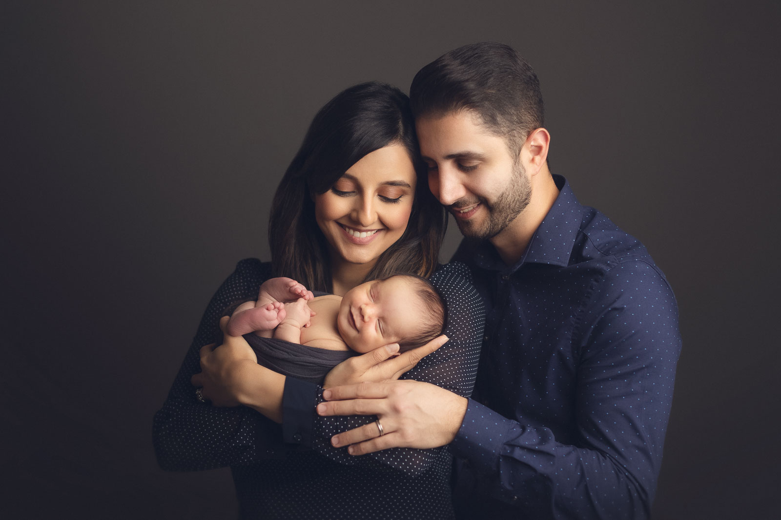 family photography with newborn - in grey dark background