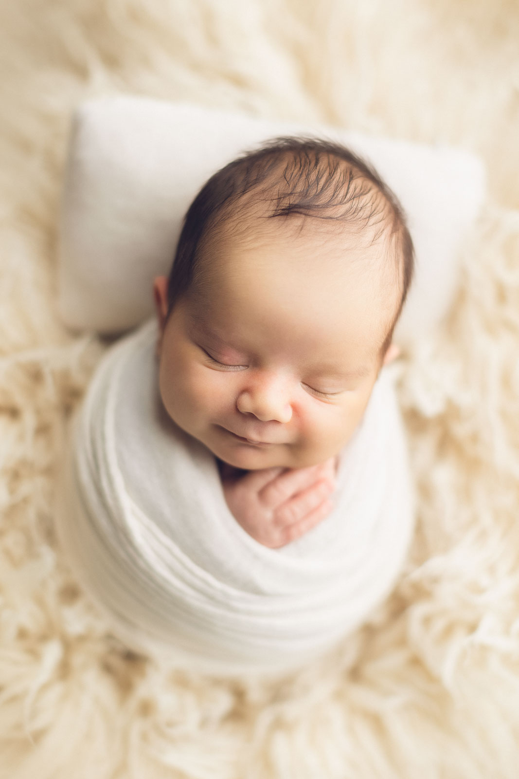 newborn photography baby boy white wrap smiling