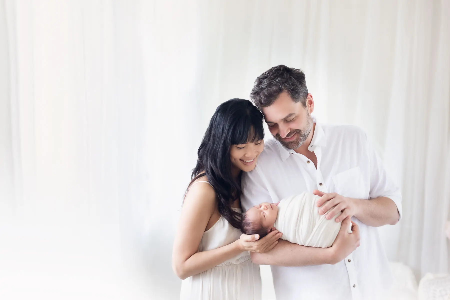 newborn photography with family in white background