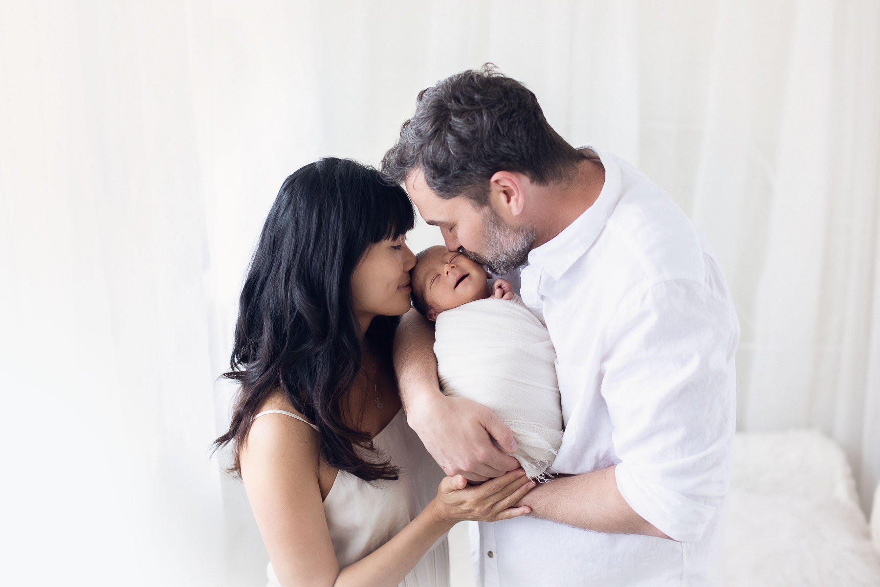 newborn photography with family in white background