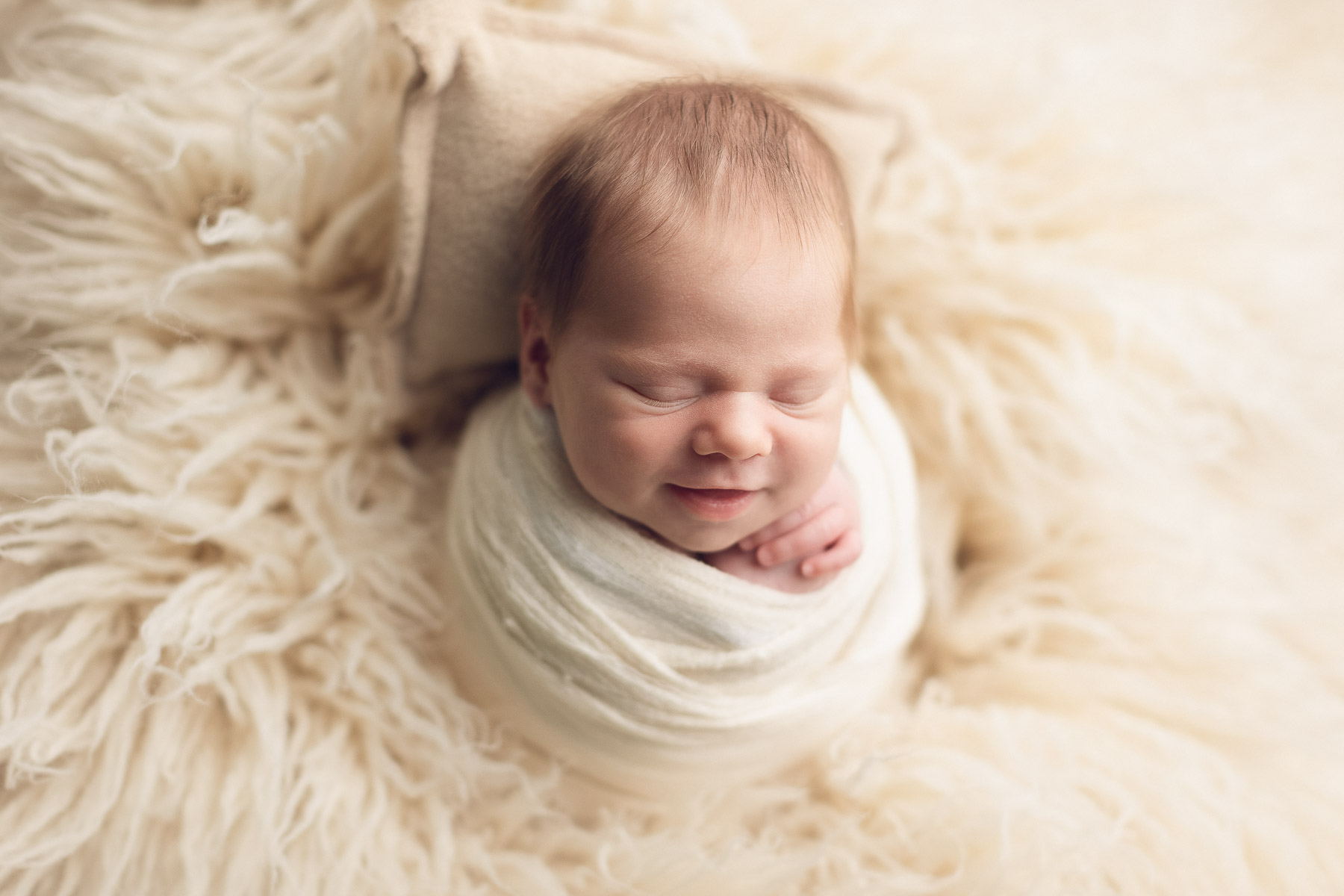 newborn baby smiling with mom and dad