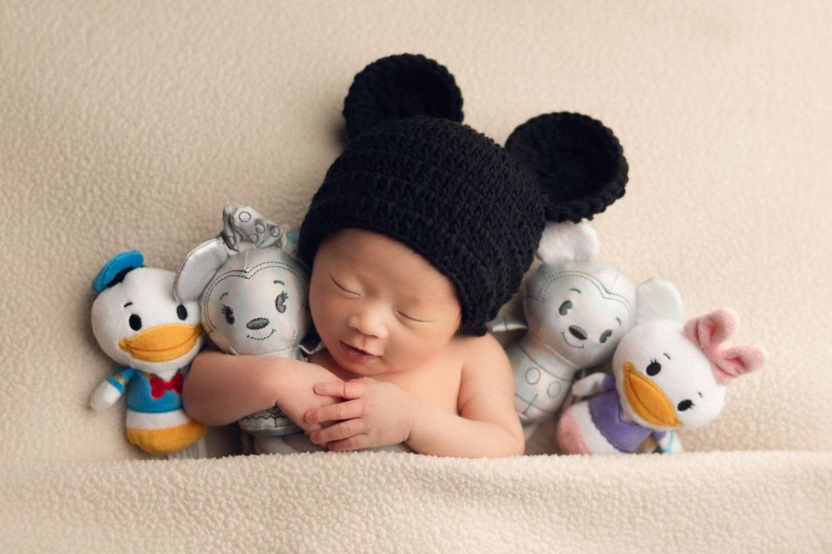 newborn photography with Disney and mickey mouse props