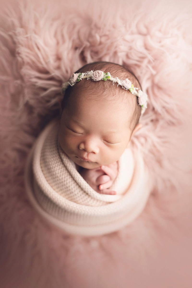 simple and clean of a newborn baby girl with headband