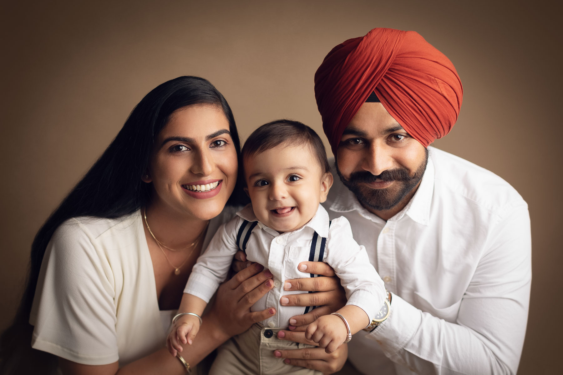 Smiling family with baby in portrait