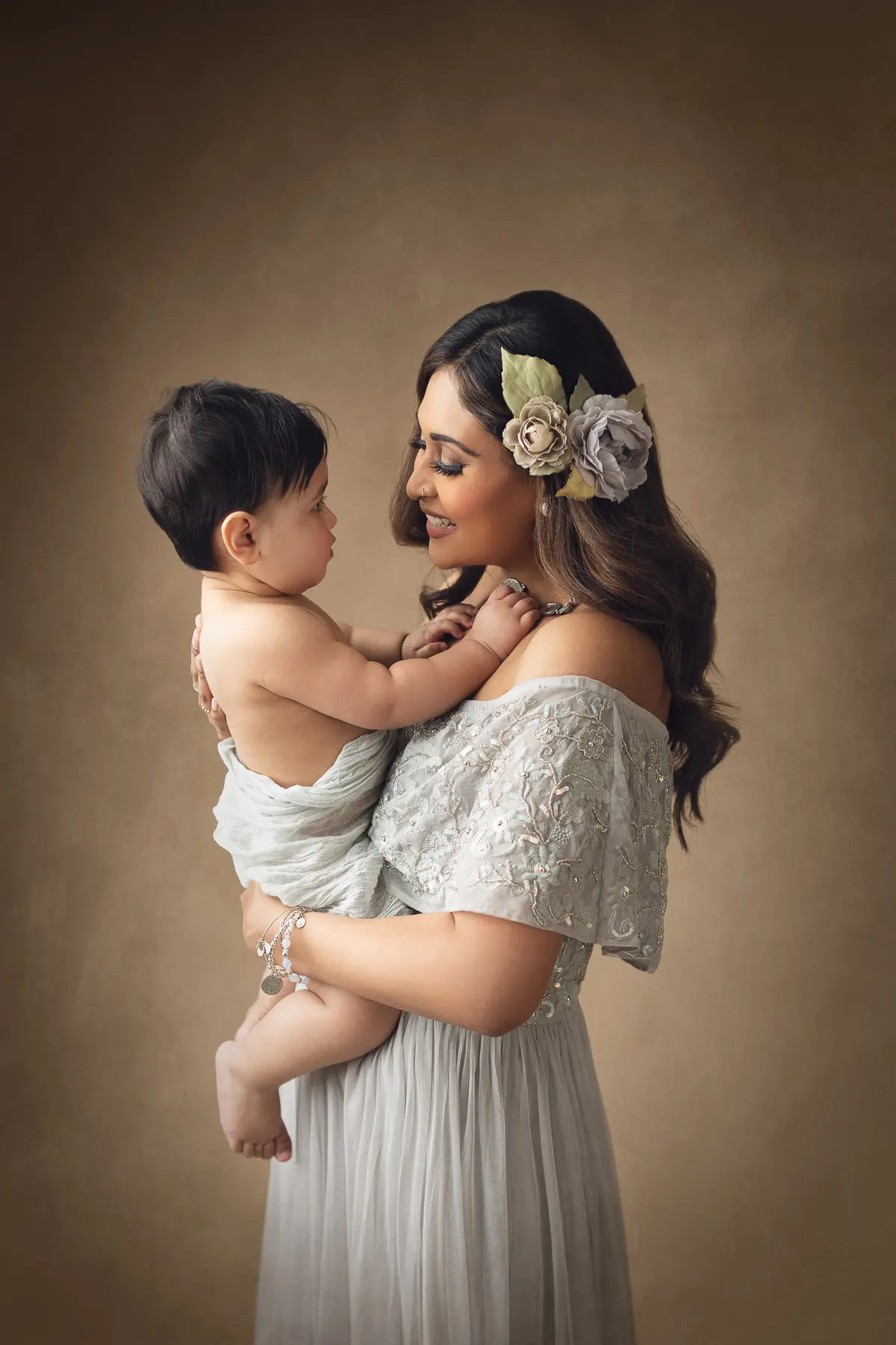 Mother holding baby, warm expression.