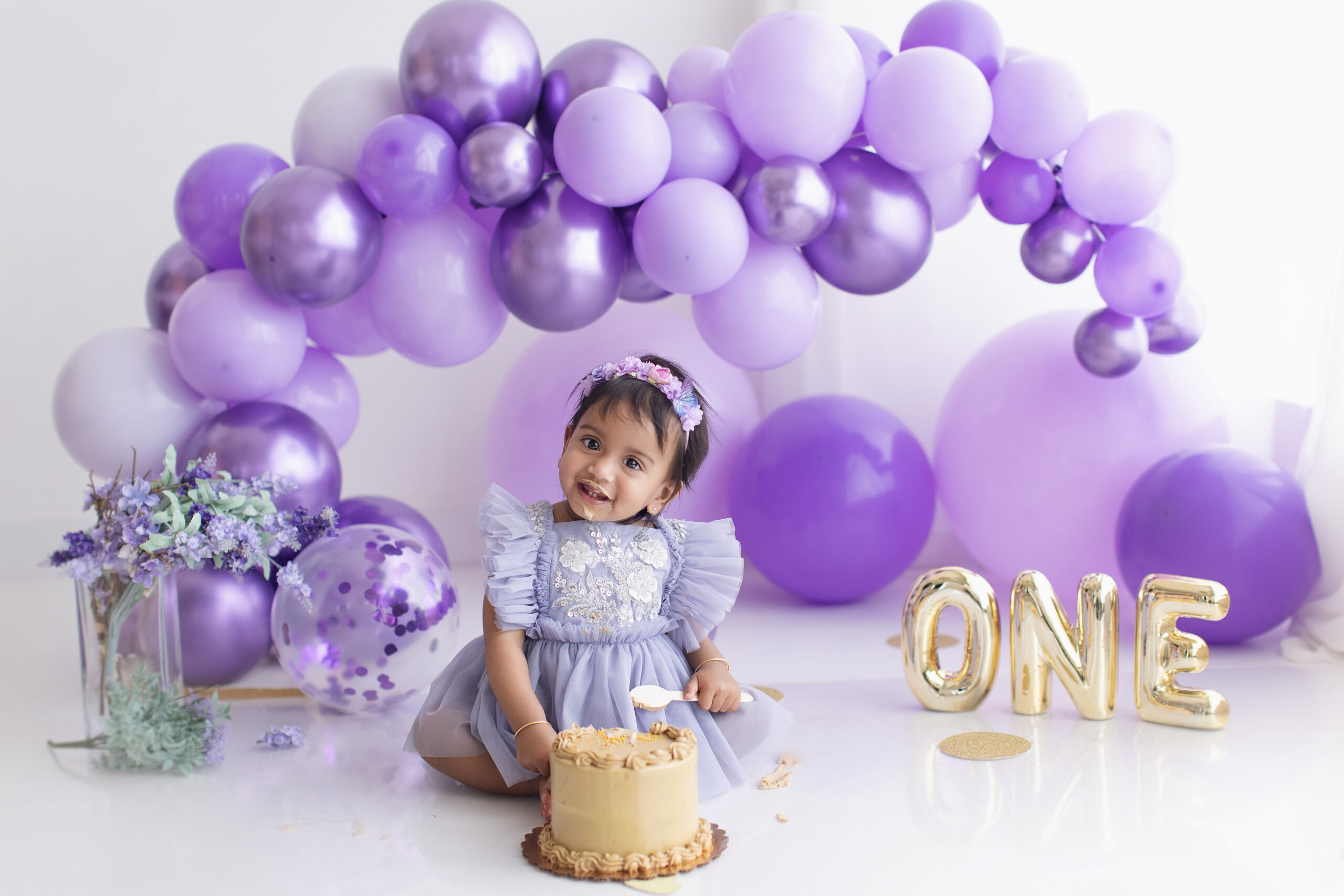 Child celebrating first birthday with cake