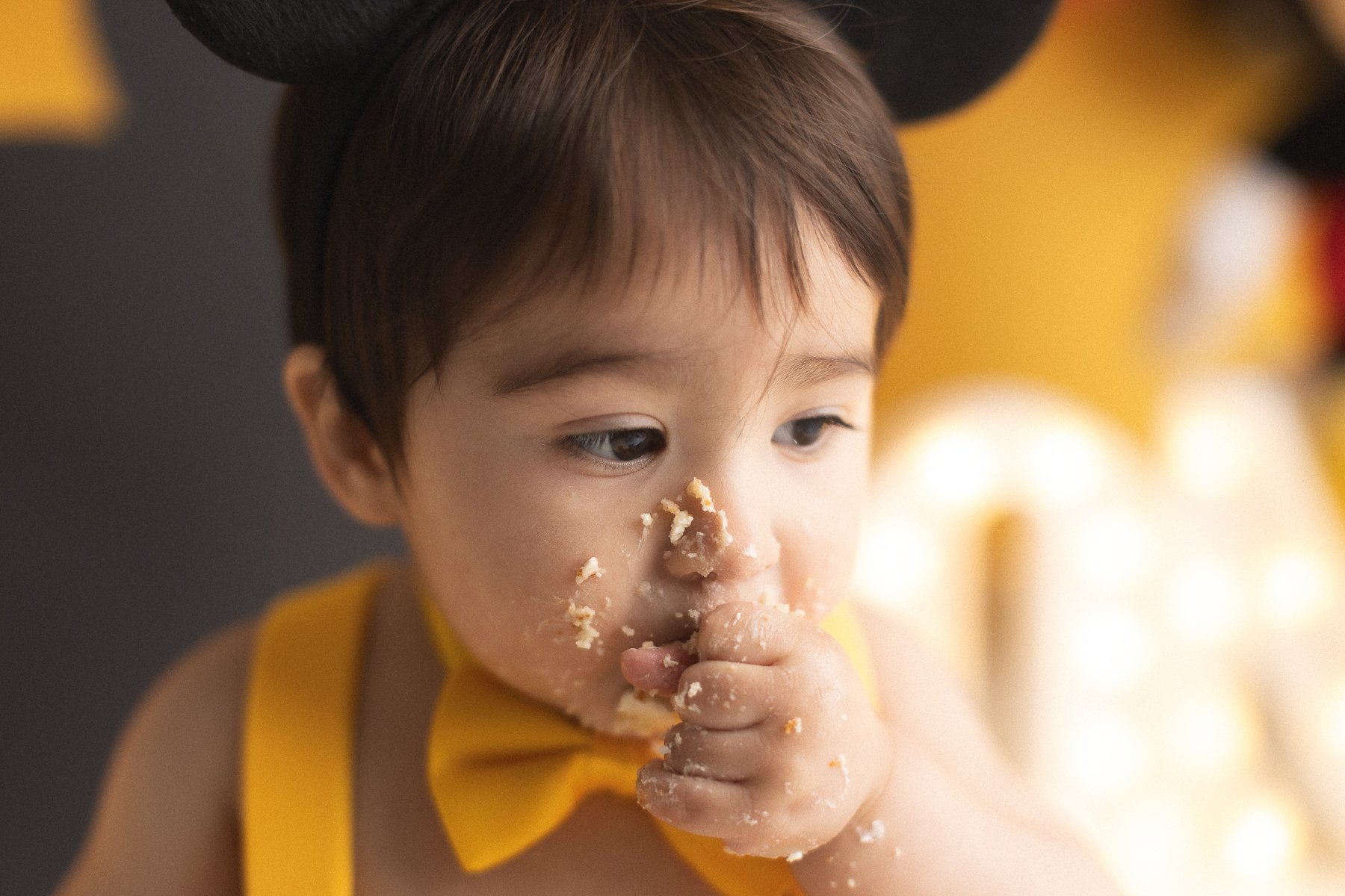 Child enjoying a cake smash celebration.