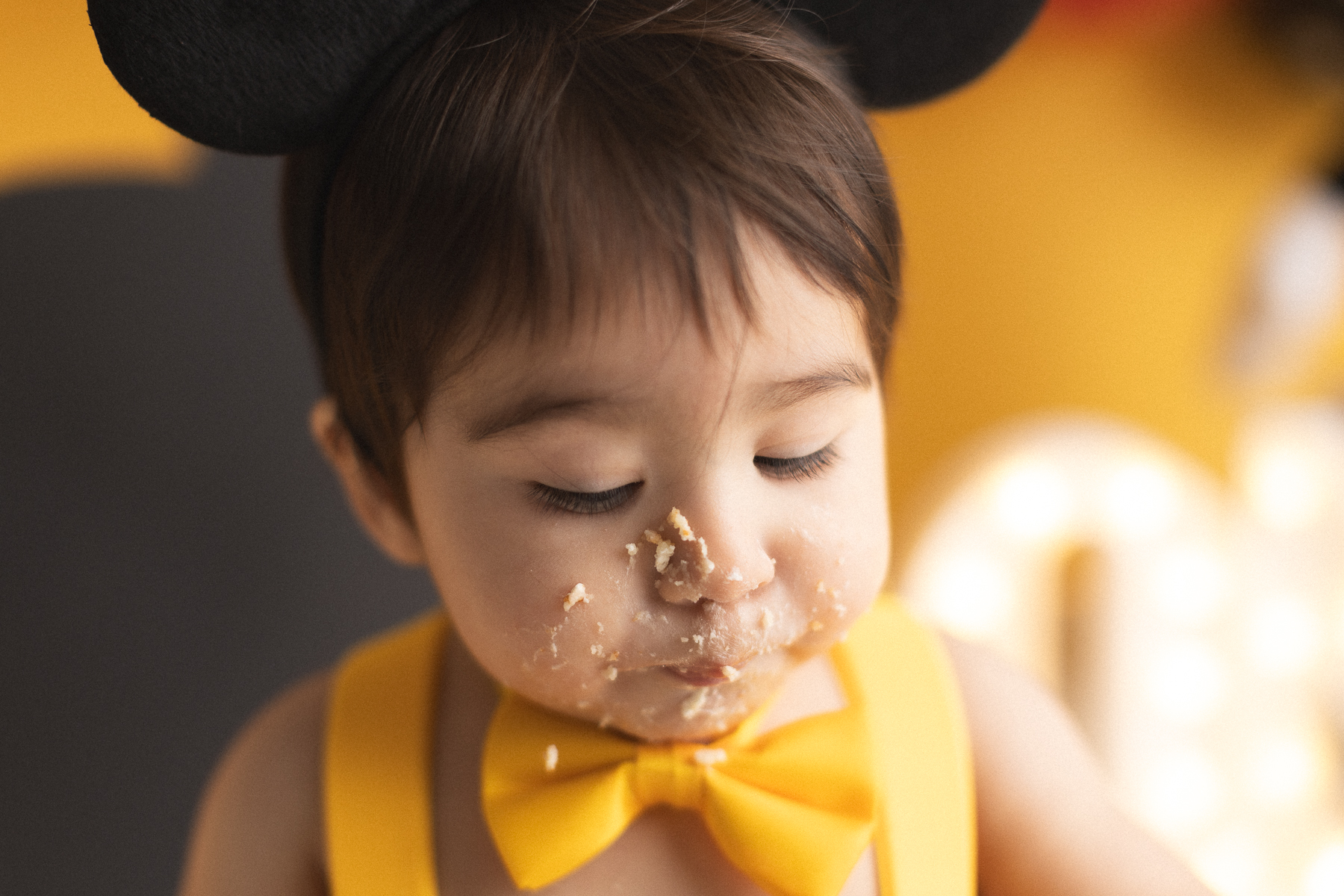 Child enjoying a cake smash celebration.