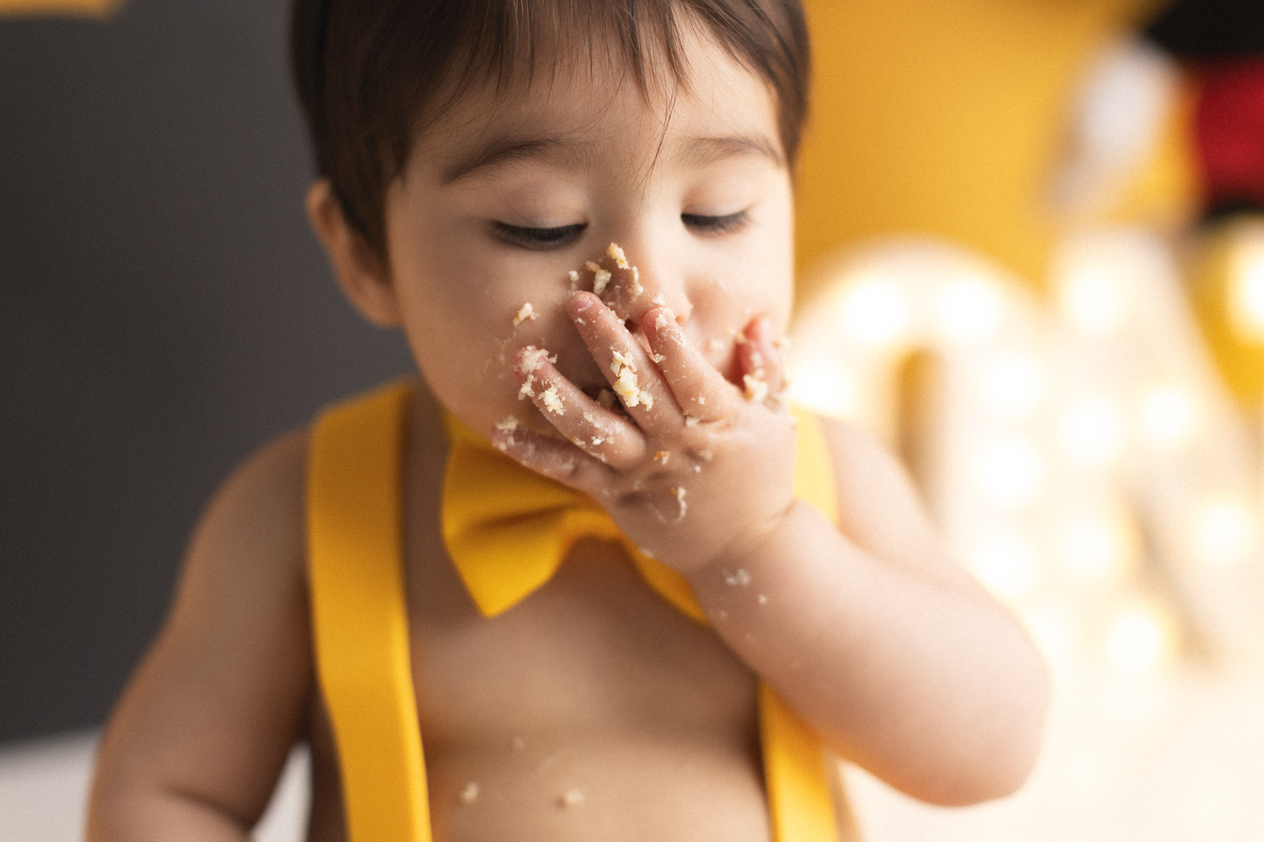 Child enjoying cake with messy hands
