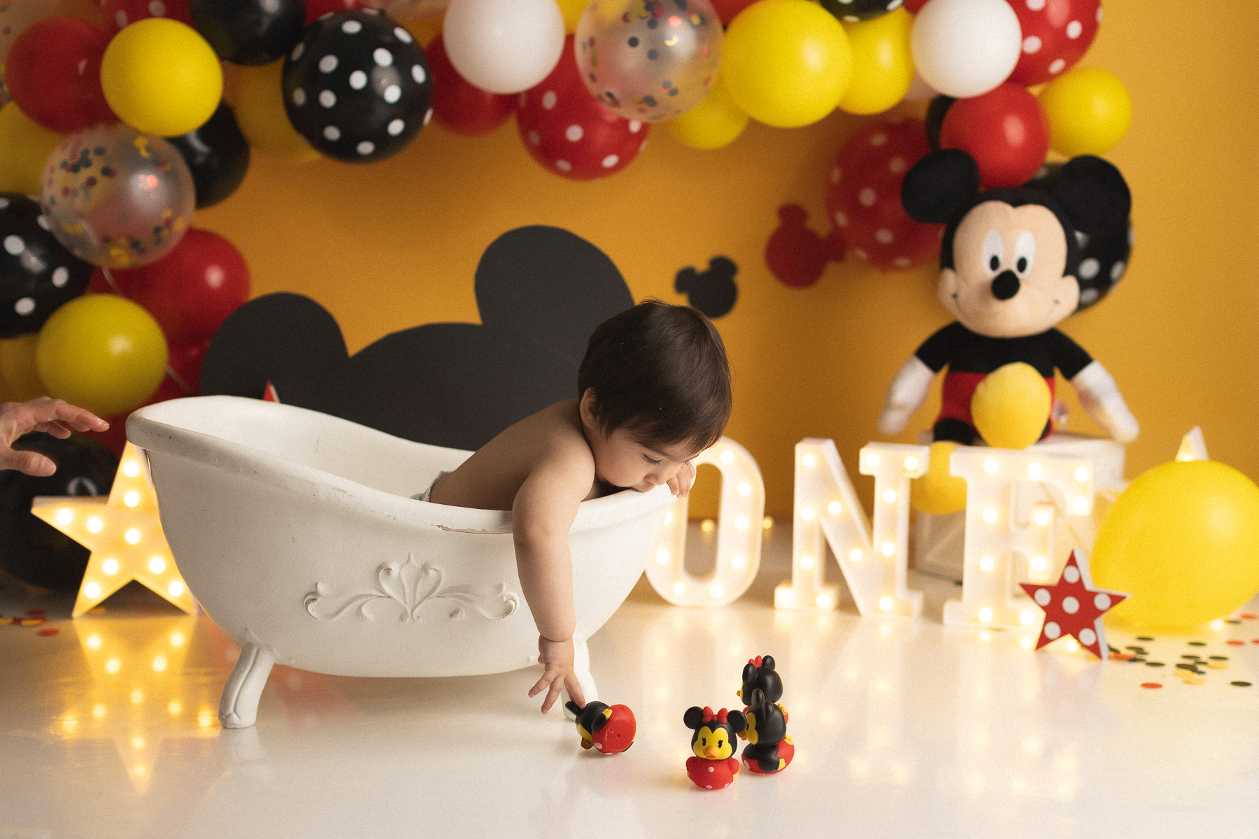 Baby in tub with Mickey decorations