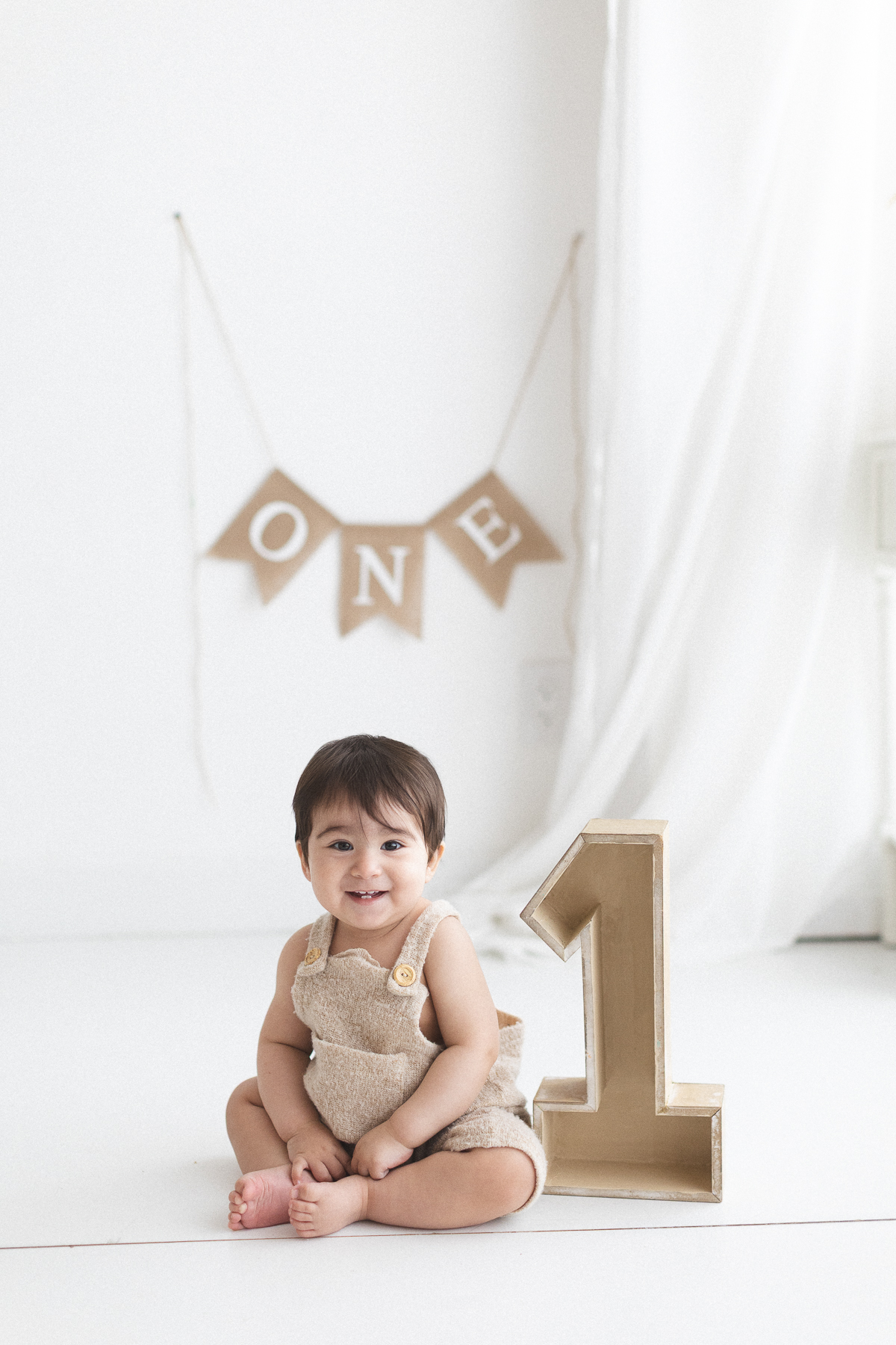 Baby sitting with number one decoration