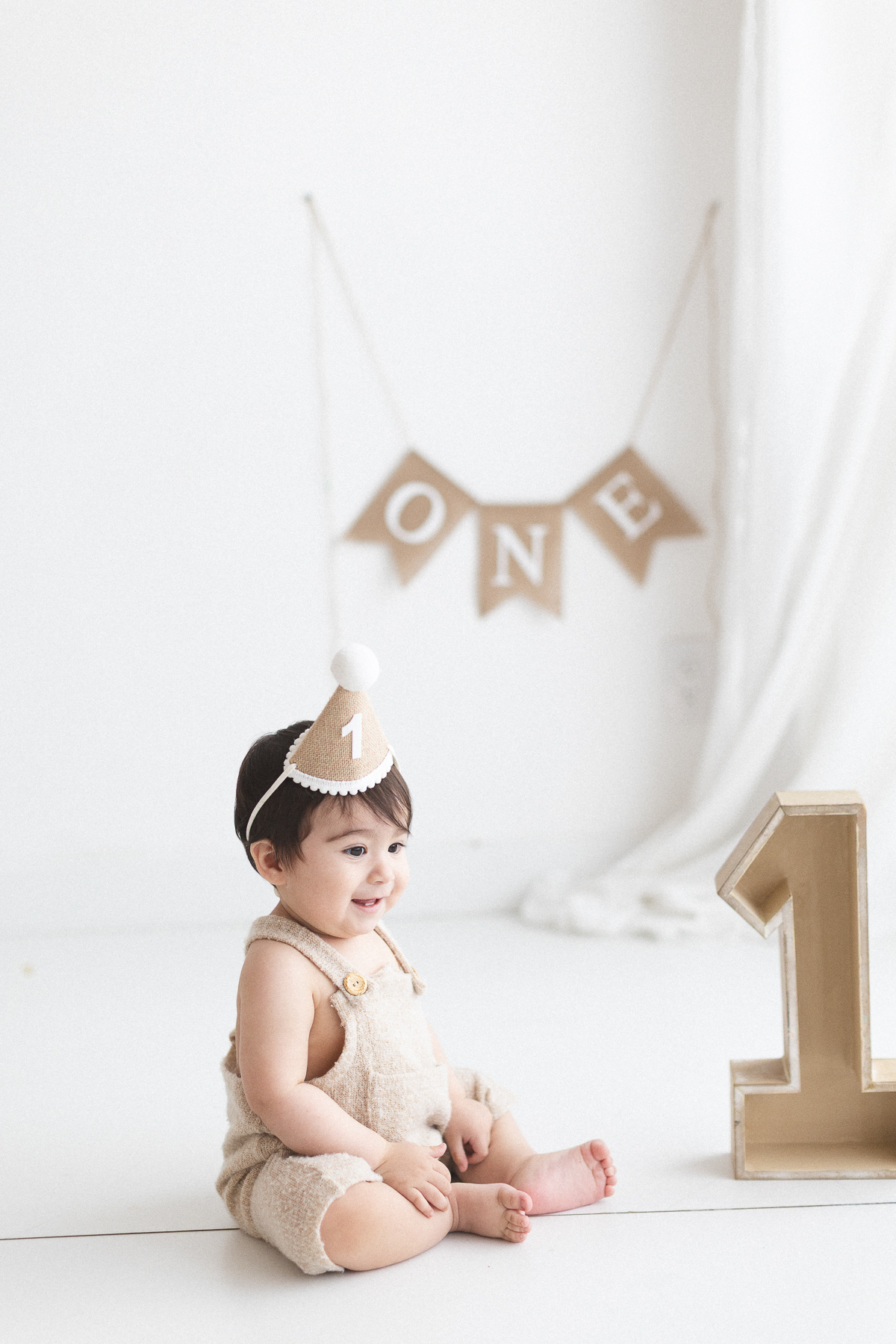 Baby celebrating first birthday with decorations