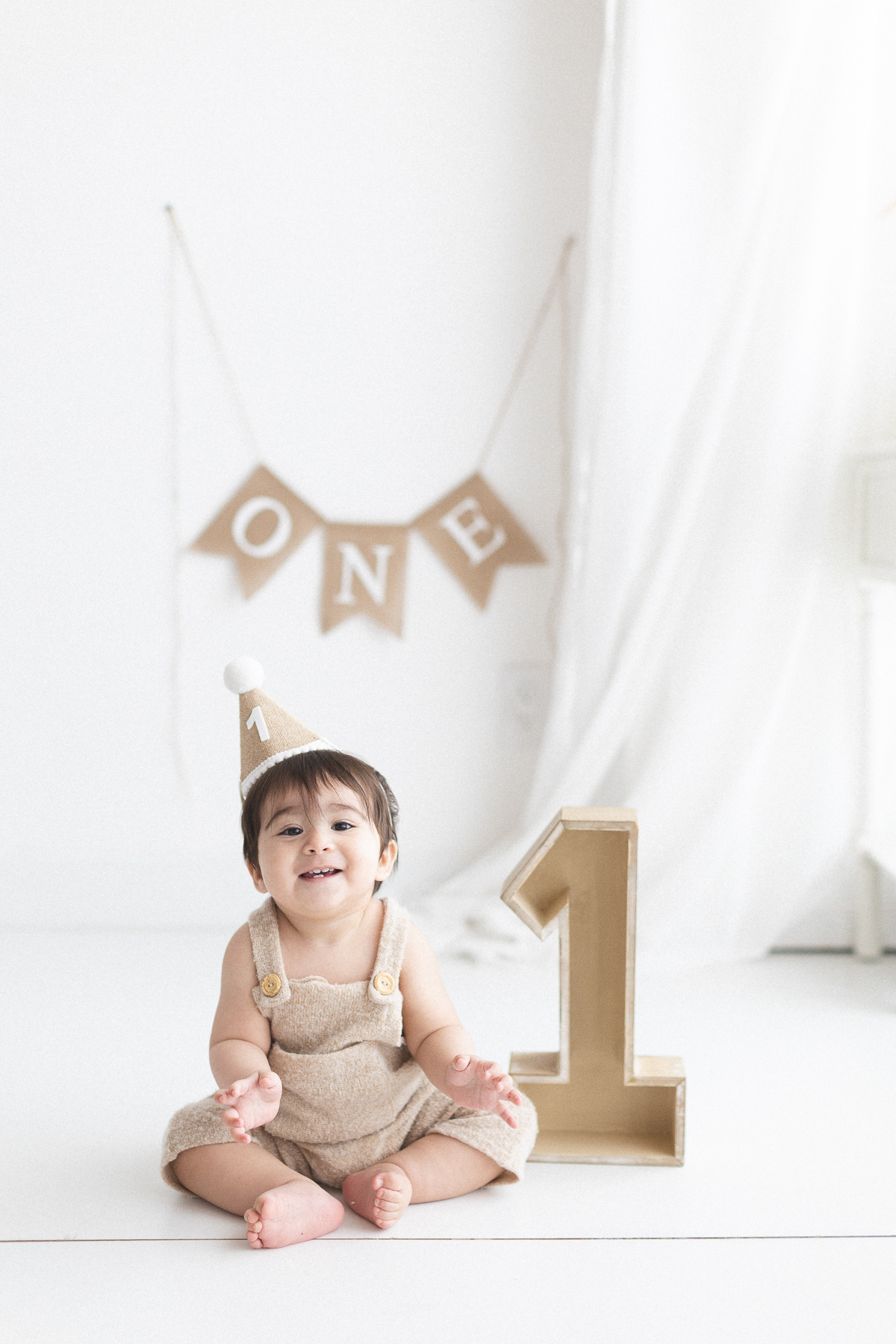 Baby celebrating first birthday, joyful expression.