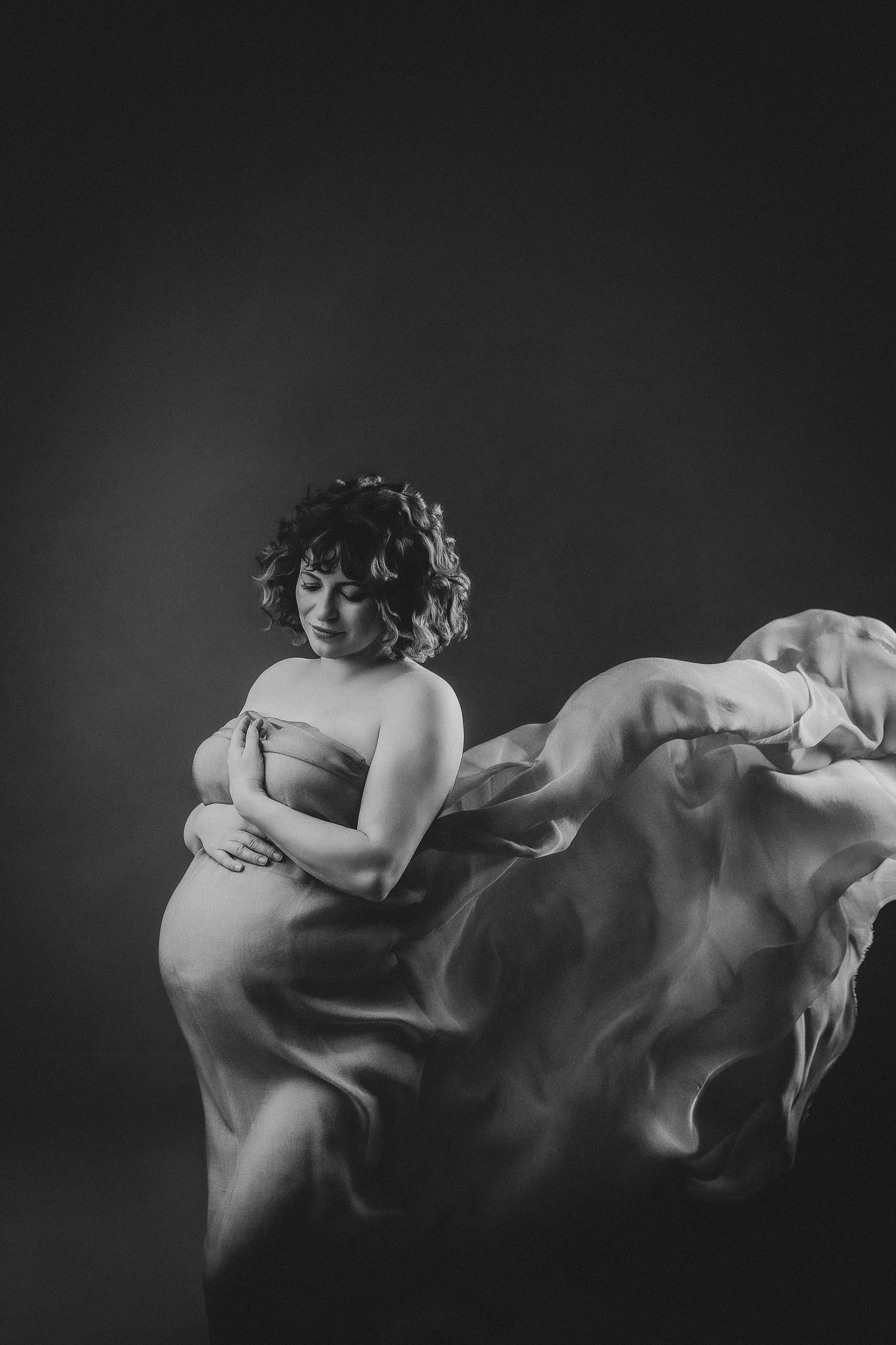 Pregnant woman in flowing fabric