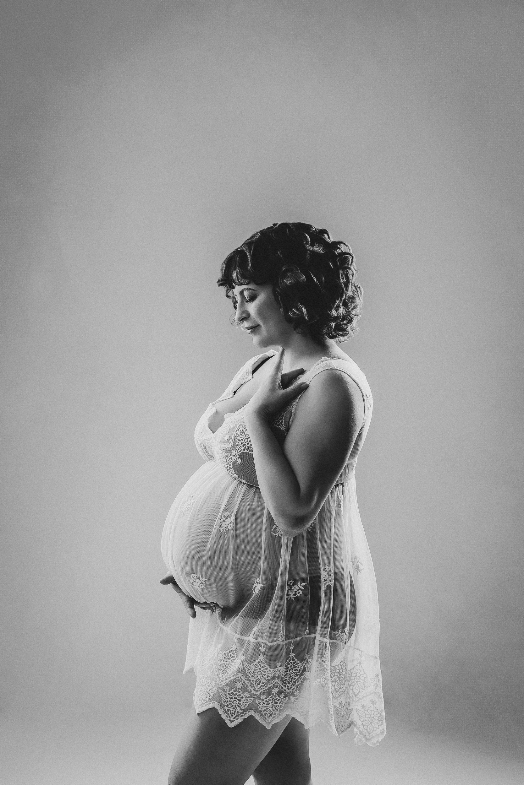 Solo maternity photoshoot in Vancouver with soft studio lighting and luxury maternity dress in black and white